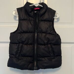 Black puffy vest. 2 pockets, fleece lined. Size 2T